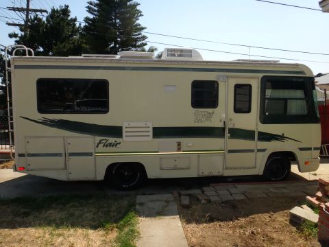 1995 Chevrolet P30 1 Ton - Step Van - This motorhome is seen from its side, with graphics and windows visible.