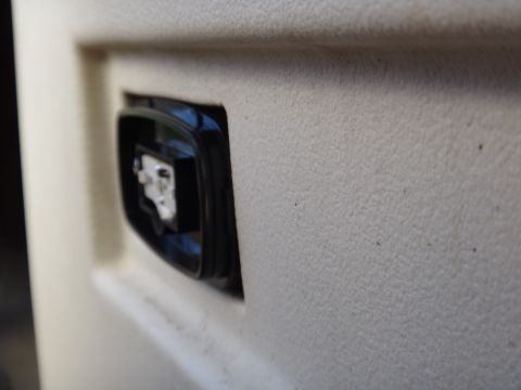 1995 Chevrolet P30 1 Ton - Step Van - A close-up view of a switch located on the interior door panel of a vehicle.