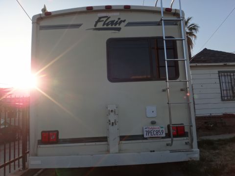 1995 Chevrolet P30 1 Ton - Step Van - Rear view of a Flair RV, showing the ladder and license plate.