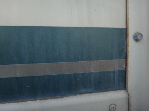 1995 Chevrolet P30 1 Ton - Step Van - Close-up of a vehicle's side panel teal and gray stripes.