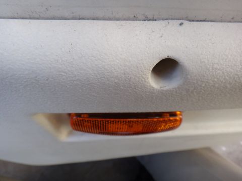 1995 Chevrolet P30 1 Ton - Step Van - A close-up view of an amber marker light assembly on a vehicle's exterior panel.