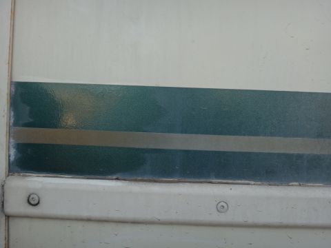 1995 Chevrolet P30 1 Ton - Step Van - Close-up of a vehicle's side panel showing a two-tone stripe detail.