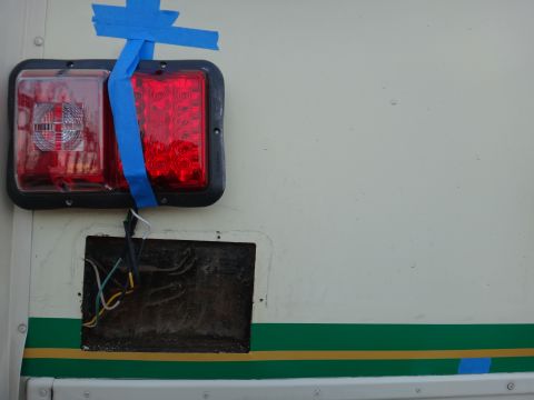 1995 Chevrolet P30 1 Ton - Step Van - Exposed wiring and temporary tail light repair on a vehicle side.