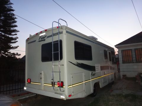 1995 Chevrolet P30 1 Ton - Step Van - Rear view of a cream-colored RV with a ladder attached to the back and "Flair" badging on the side.