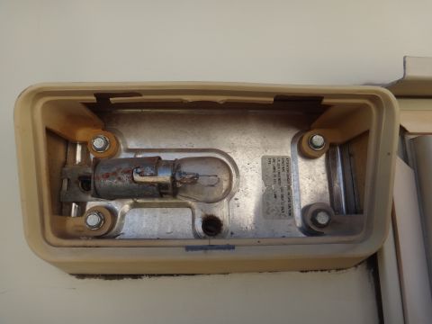 1995 Chevrolet P30 1 Ton - Step Van - This is an interior light fixture, likely from a van or RV, showing a removed bulb and a label with some text.