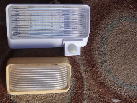 1995 Chevrolet P30 1 Ton - Step Van - Comparison of a modern LED interior light with a motion sensor next to an older incandescent light fixture.