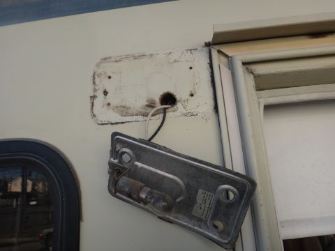 1995 Chevrolet P30 1 Ton - Step Van - A light fixture is detached from the side of a vehicle, exposing wiring.