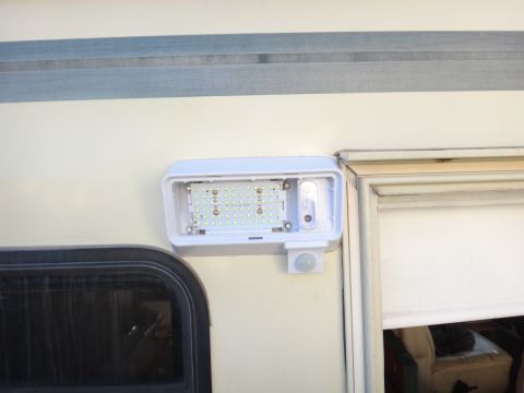 1995 Chevrolet P30 1 Ton - Step Van - An exterior RV light fixture with a motion sensor is mounted on the side of the vehicle.