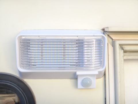 1995 Chevrolet P30 1 Ton - Step Van - This exterior RV light features a motion sensor and a bright LED array, mounted on the vehicle's side.