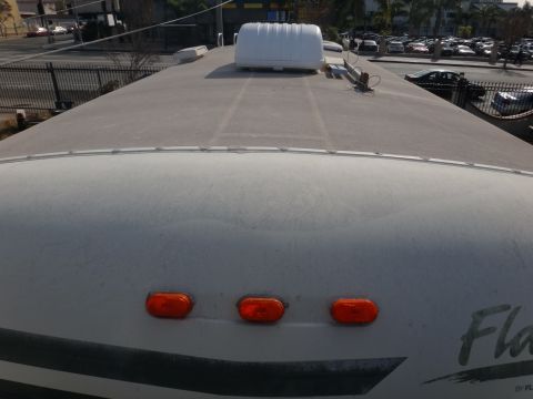1995 Chevrolet P30 1 Ton - Step Van - The top of an RV shows three amber marker lights and a large white roof-mounted unit.