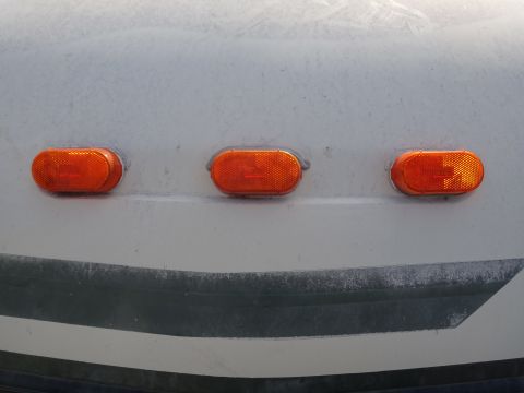 1995 Chevrolet P30 1 Ton - Step Van - Close-up view of three orange marker lights on the exterior of a vehicle.