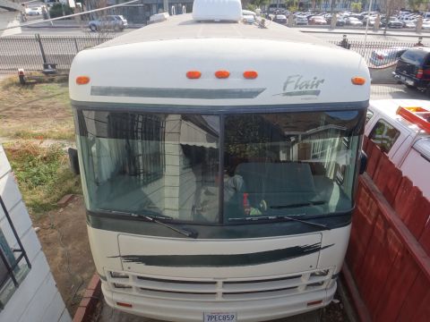 1995 Chevrolet P30 1 Ton - Step Van - Front view of a white RV, identified by the 'Flair' logo on the upper right of the windshield area.