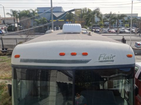 1995 Chevrolet P30 1 Ton - Step Van - The top section of an RV, identified as 'Flair', is visible with roof vents and marker lights.