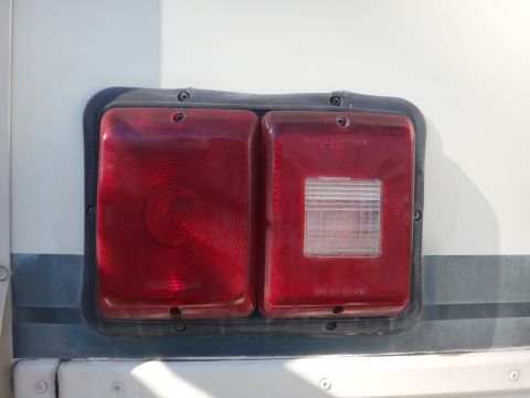 1995 Chevrolet P30 1 Ton - Step Van - The rear lights of a vehicle are shown, with visible text indicating DOT compliance.