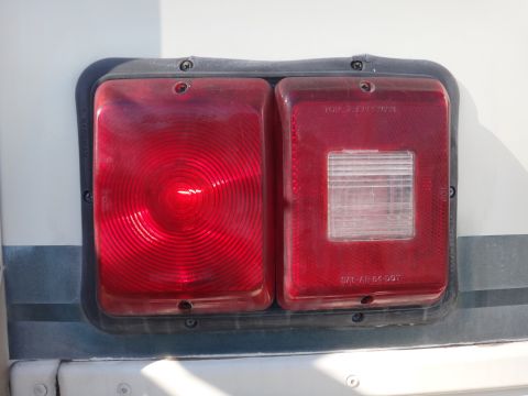 1995 Chevrolet P30 1 Ton - Step Van - Close-up of a vehicle's rear taillight assembly, showing both red and clear sections.
