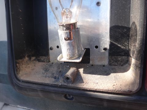 1995 Chevrolet P30 1 Ton - Step Van - The interior of a vehicle's light housing, showing the socket where a bulb would be installed.