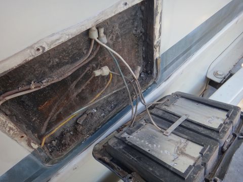 1995 Chevrolet P30 1 Ton - Step Van - A look inside a vehicle's wiring compartment, showing exposed wires and a detached component.