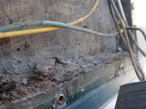 1995 Chevrolet P30 1 Ton - Step Van - Detail of wiring and accumulated dirt on a vehicle's body, showing signs of wear and tear.