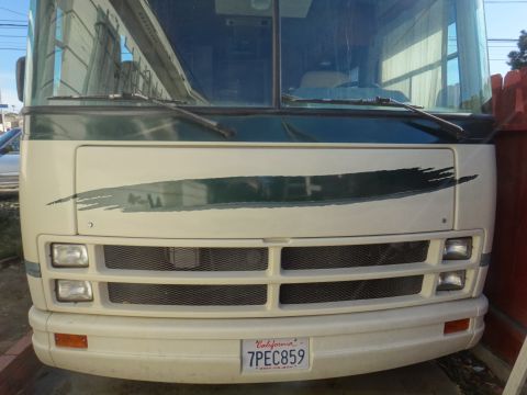 1995 Chevrolet P30 1 Ton - Step Van - The front of a white step van is shown, a green stripe graphic and a California license plate.