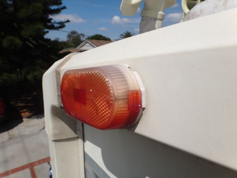 1995 Chevrolet P30 1 Ton - Step Van - Close-up of an orange marker light on the side of a white step van.