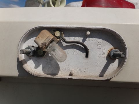 1995 Chevrolet P30 1 Ton - Step Van - This is a close-up of a vehicle tail light assembly, showing the bulb and mounting hardware. Text indicates 'DOT P2 85'.