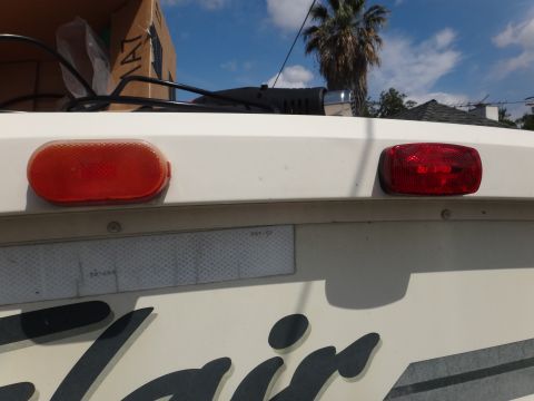 1995 Chevrolet P30 1 Ton - Step Van - Close-up of the rear lights and partial branding on a vehicle.
