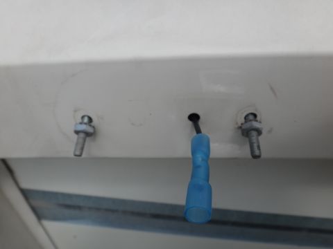 1995 Chevrolet P30 1 Ton - Step Van - A blue electrical connector is attached to a wire, with two bolts nearby on the surface above.
