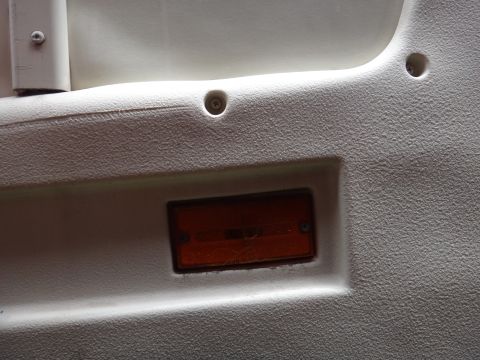 1995 Chevrolet P30 1 Ton - Step Van - Close-up of an interior panel showing a textured surface and an amber marker light, with website text at the bottom.