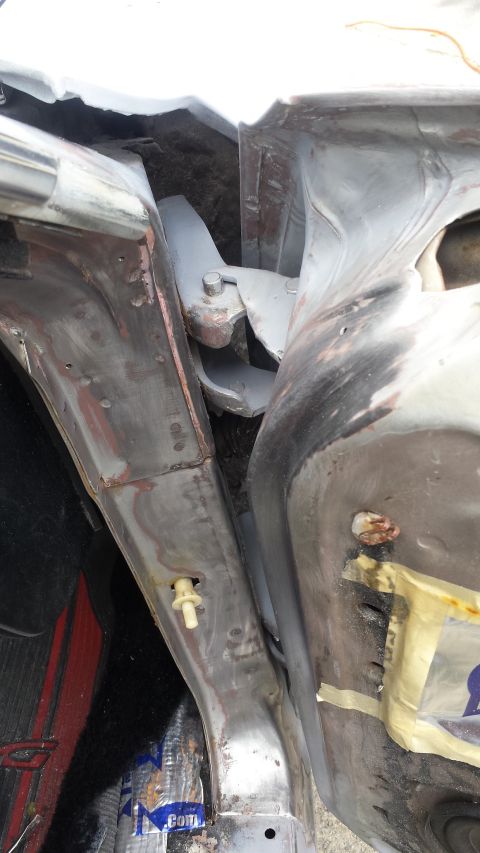 1976 Ford Ranchero - Close-up view of the door hinge area of a vehicle, likely a Ford Ranchero, during restoration work.