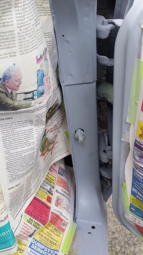 1976 Ford Ranchero - Newspaper is used to mask off areas during auto body work on a car's door jamb.
