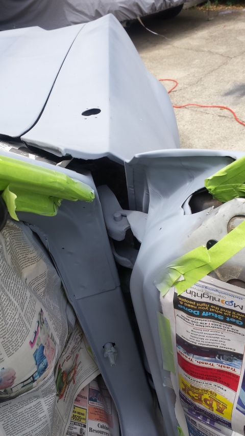 1976 Ford Ranchero - Close-up of a vehicle's bodywork undergoing preparation for painting, with protective materials in place.