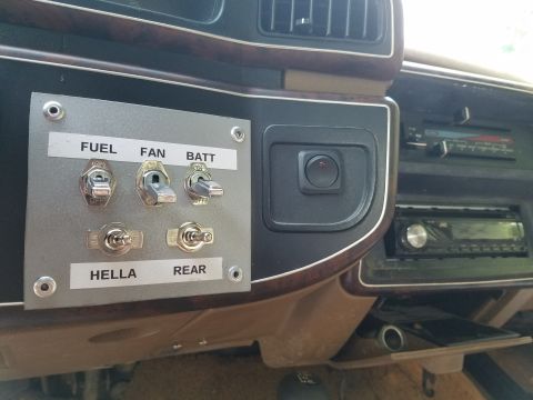 1988 Ford Bronco - A close-up view of a vehicle's interior dashboard, highlighting a custom-installed switch panel.
