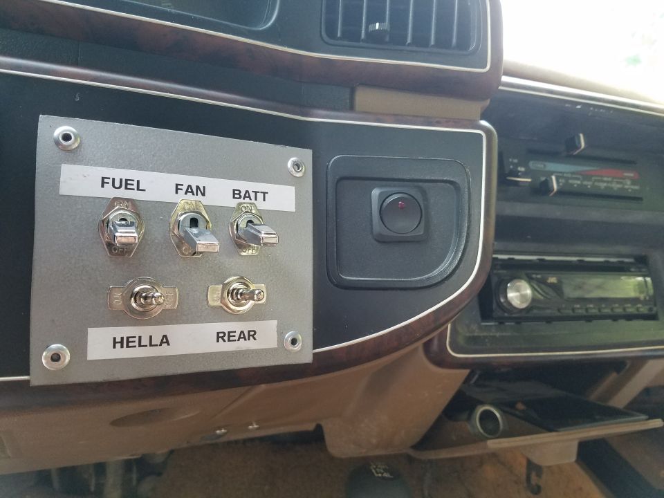 Custom switch panel with labels for fuel, fan, batt, hella, and rear. Also shows a radio and air vents