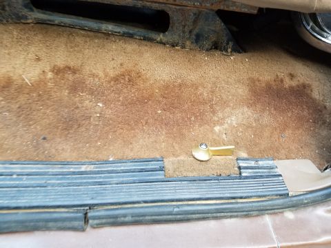 1988 Ford Bronco - The interior floor and door sill show signs of wear and tear, with a visible gold latch.