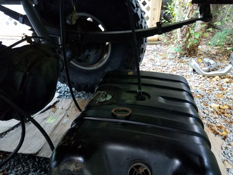 Fuel tank and leaf spring assembly