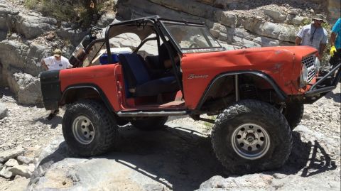 1979 Ford Bronco - This modified Ford Bronco is navigating a rocky trail, its off-road capabilities.