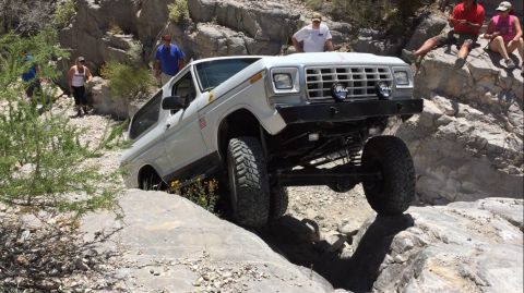 1979 Ford Bronco - This modified Ford Bronco navigates a rocky incline, its off-road capabilities.