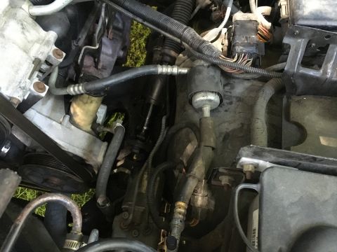 1993 Ford Bronco - Close-up view of various engine components, including hoses and electrical connections.