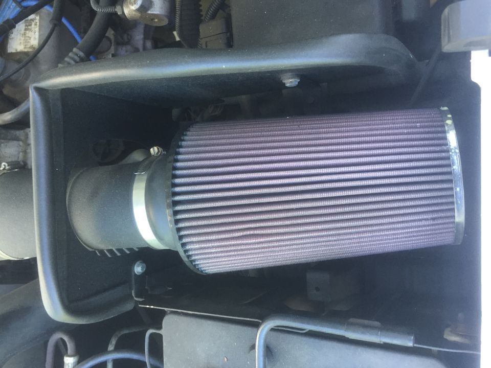 Engine air filter with purple element and black housing