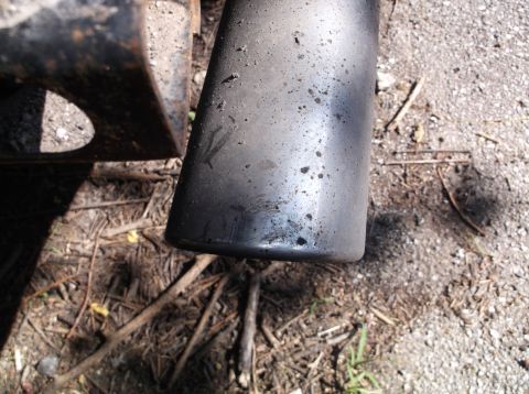 1999 Mercury Grand Marquis - A close-up view of a vehicle's exhaust pipe, showing signs of wear and tear.