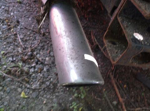 1999 Mercury Grand Marquis - Close-up of a vehicle's exhaust pipe, showing a piece of white tape on its surface.