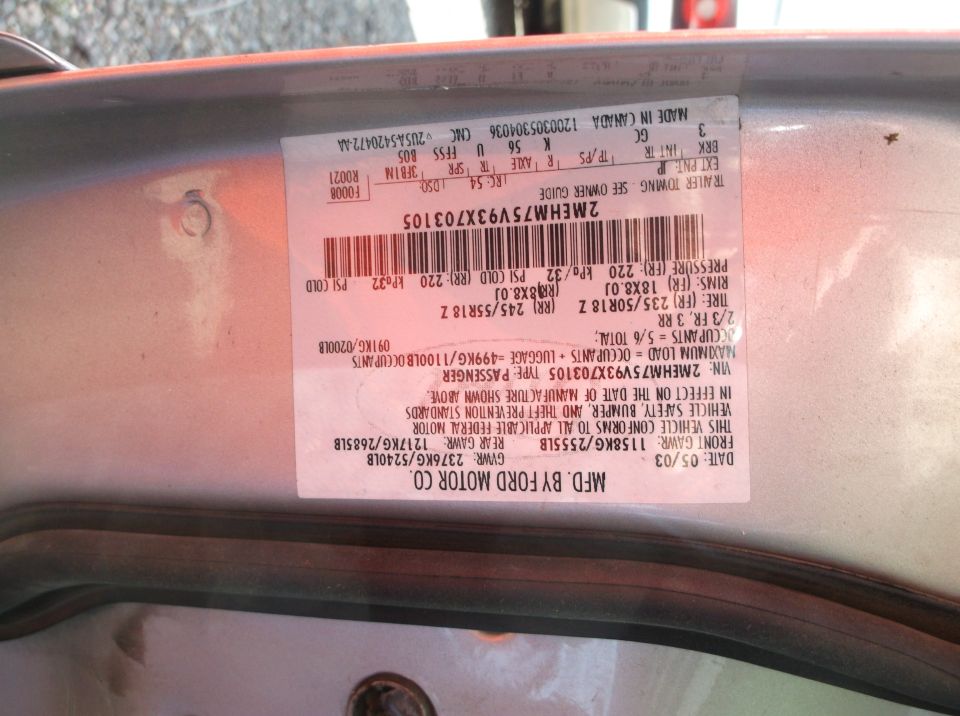 Ford Motor Co. certification label dated 05/03 with VIN 2MEHM75V93X703105, photographed upside down