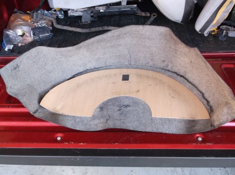 1999 Mercury Grand Marquis - A car trunk liner is shown with a template, placed in the bed of a red truck.
