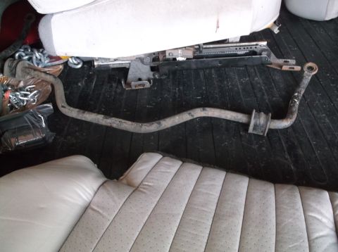 1999 Mercury Grand Marquis - A car's sway bar and seat cushions are visible on a dark, slatted surface.