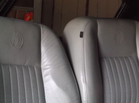 1999 Mercury Grand Marquis - Close-up of two car seats, one with an embossed emblem, showing interior details.