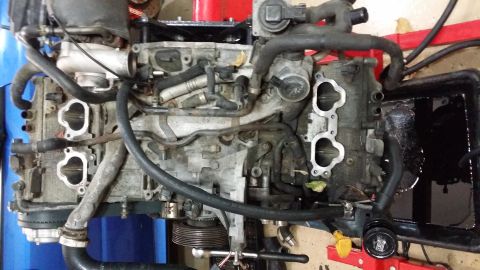 2007 Subaru Impreza - Engine assembly shown with various hoses and intake manifolds attached, likely undergoing maintenance or repair.