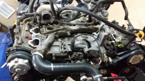 2007 Subaru Impreza - Engine assembly with turbocharger, hoses, and belts visible, showing signs of use.