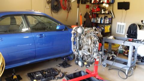 2007 Subaru Impreza - Blue 2007 Subaru Impreza sedan with engine removed for build, tools scattered around.