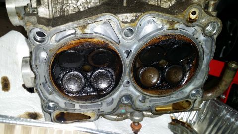 2007 Subaru Impreza - Close-up of a dirty engine cylinder head with valves and carbon deposits visible.
