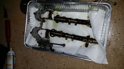 2007 Subaru Impreza - Engine camshafts and valve train components are laid out in a foil pan on paper towels.